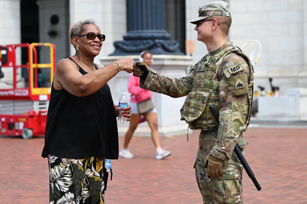 A D.C. Army National Guard soldier fist-bumps a civilian outside Union Station.