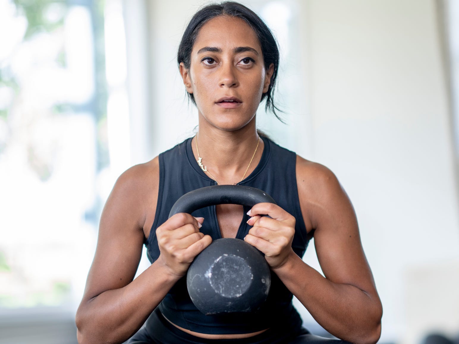 A woman holding a kettlebell