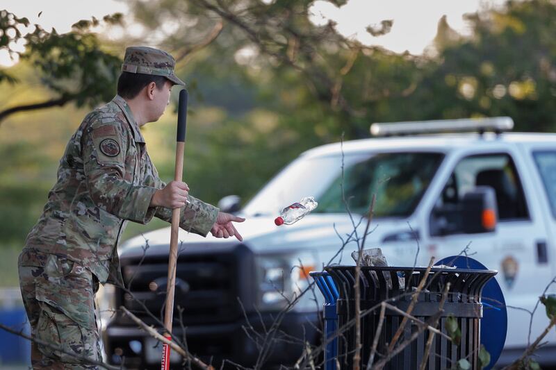 A National Guard troop discarding a bottle near the National Mall—tasks typically falling to the National Park Service are being picked up by the Guard after Trump slashed the federal workforce.