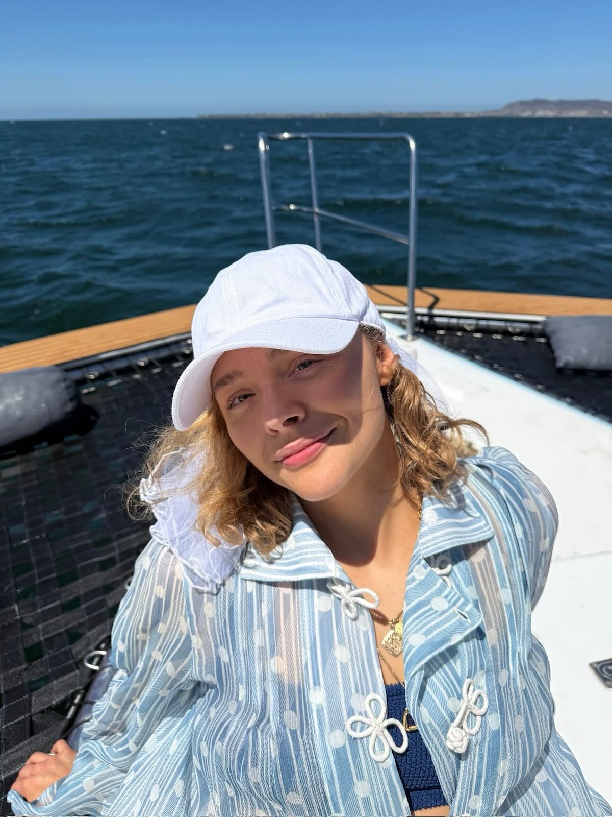 Chloë Grace Moretz soaks up the sunshine on a boat.