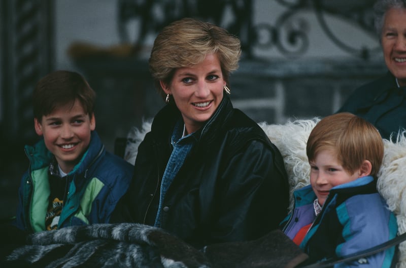 Diana, Princess of Wales riding in a traditional sleigh with Prince William and Prince Harry during a skiing holiday in Lech, Austria