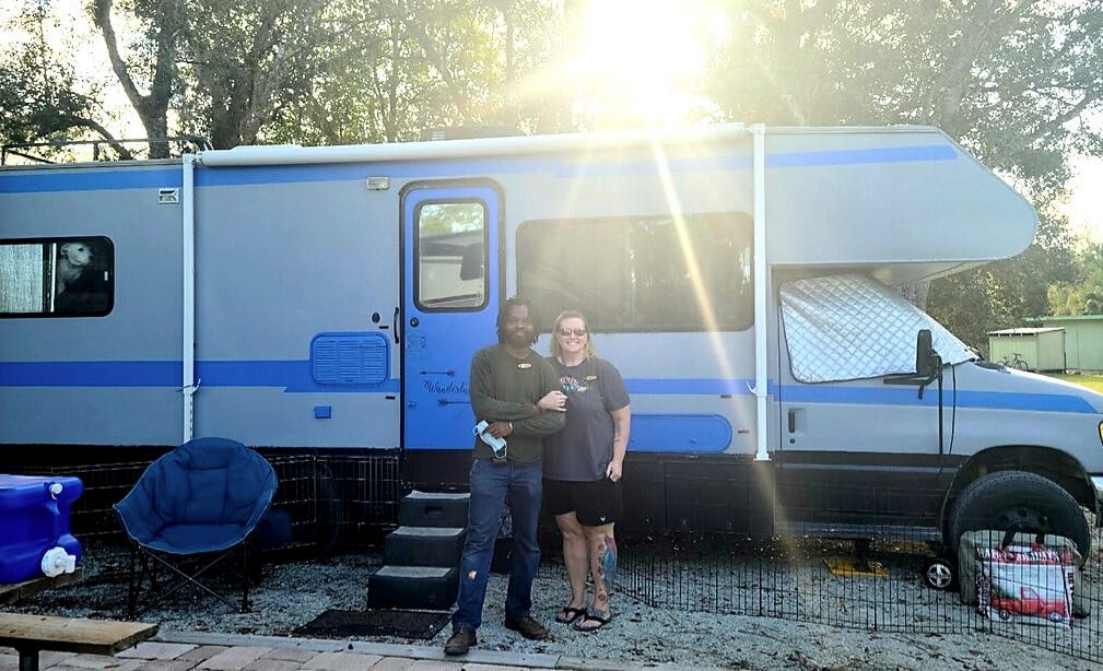 Childers and Landrum with their 1992 Tiffin Allegro RV after they remodeled it.