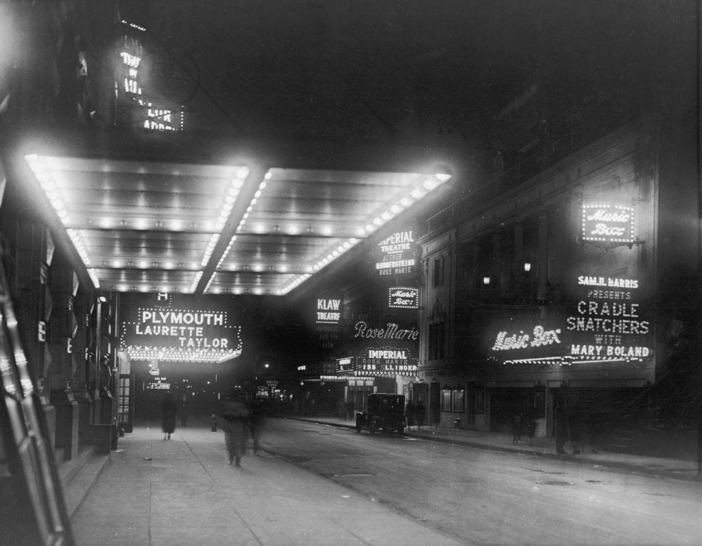 View of marquees featuring the Plymouth Laurette Taylor, the Music Box, the Imperial, and the Klaw Theaters along 45th Street in Times Square.
