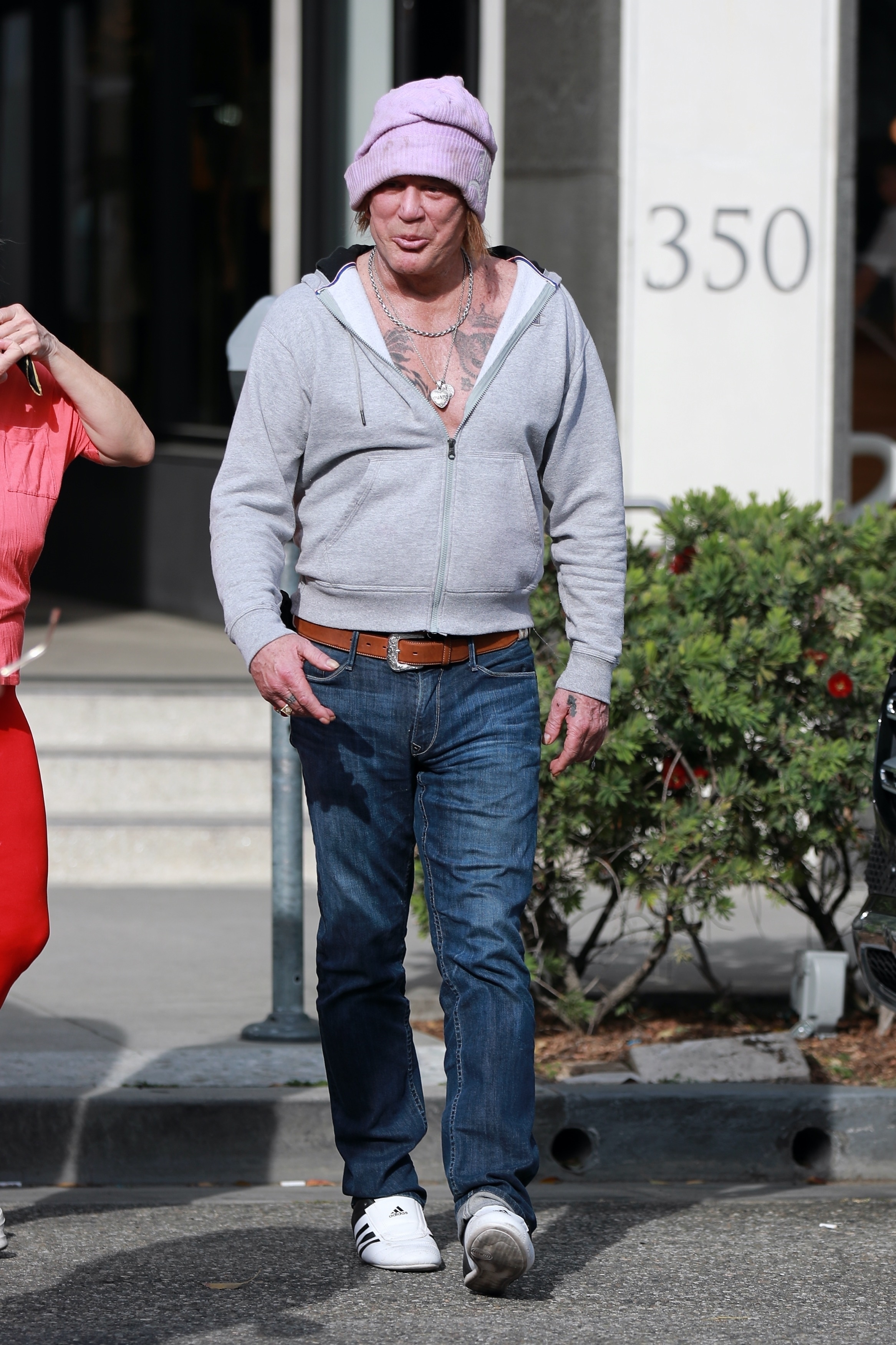 Mickey Rourke in a gray hoodie. 
