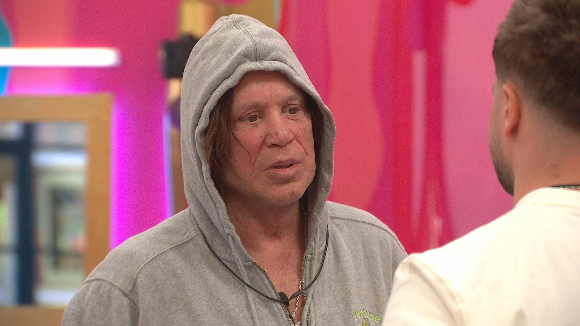 Mickey Rourke in a gray hoodie. 