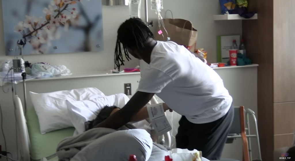 Travis Hunter comforting his wife Leanna Lenee in a YouTube video announcing the birth of their son.