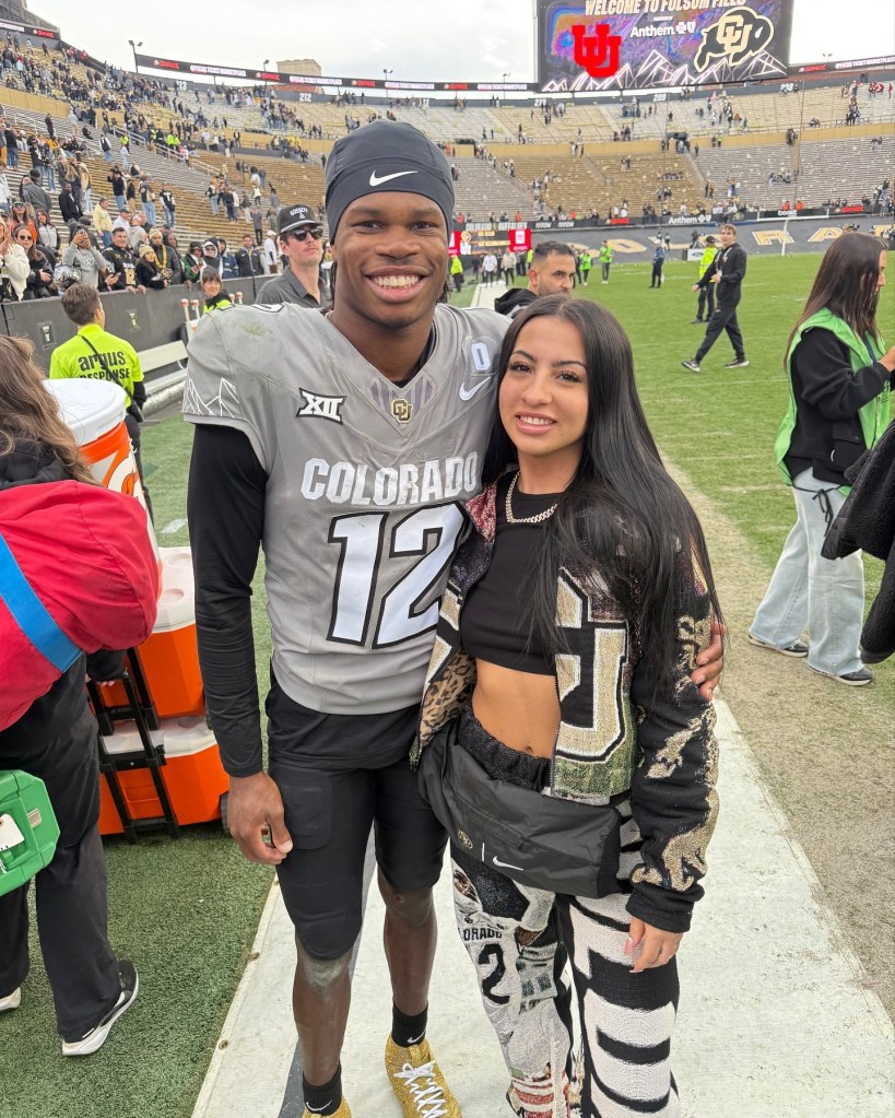 Travis Hunter and Leanna Lenee on the football field.