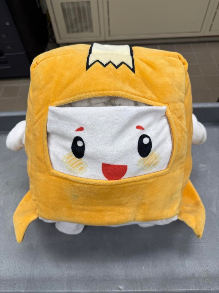 Yellow plush toy with a face.