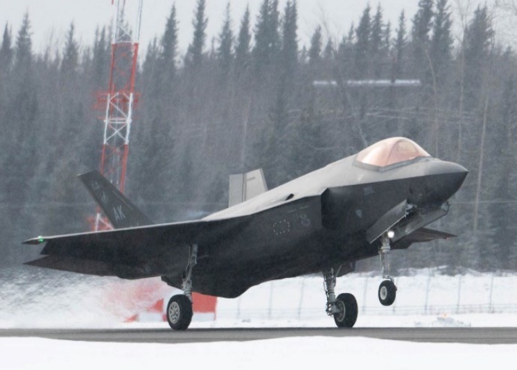 F-35A Lightning II landing on a snowy runway.