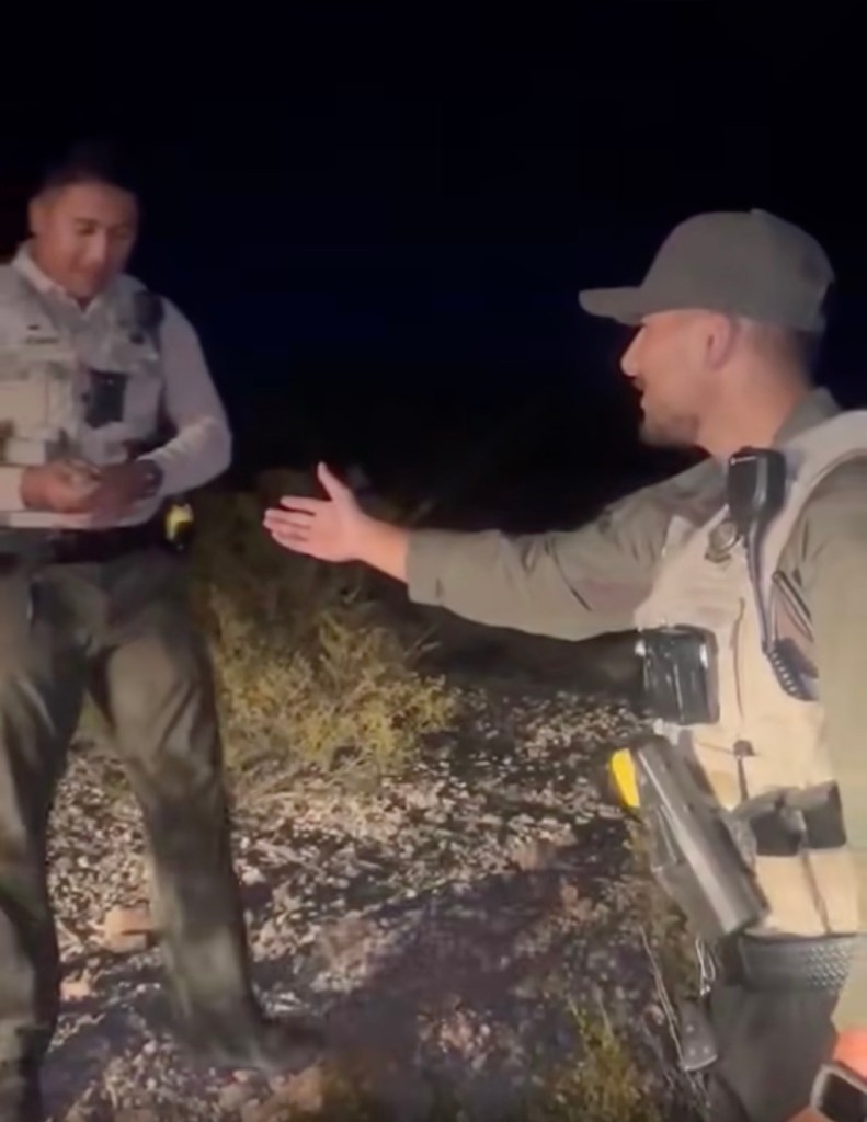 Two officers talking at night.