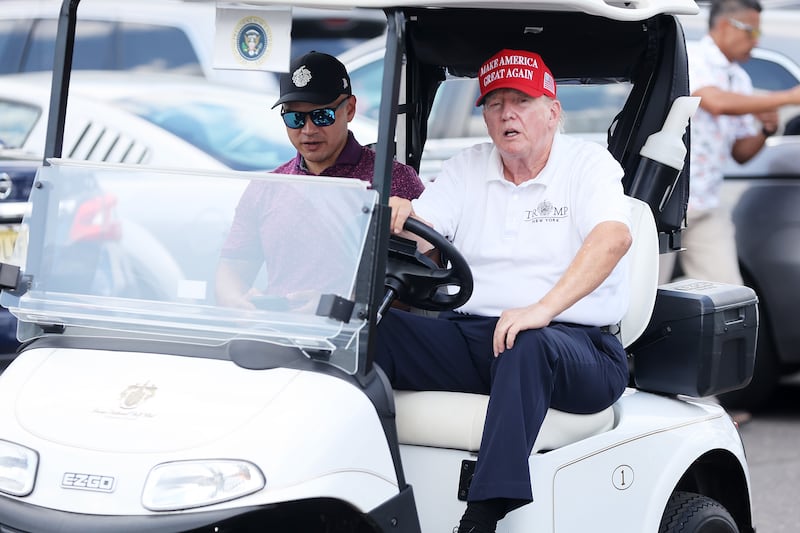 Former President Donald Trump drives a golf cart accompanied by aide Walt Nauta prior to the start of day three of the LIV Golf Invitational - Bedminster at Trump National Golf Club on Aug. 13, 2023 in Bedminster, New Jersey.