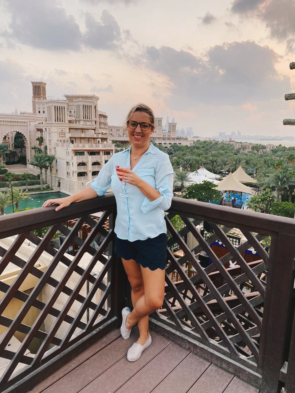 woman in blue shirt smiling for camera