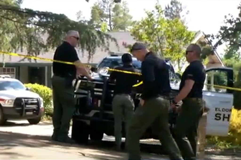 Police outside the home where the murders took place.
