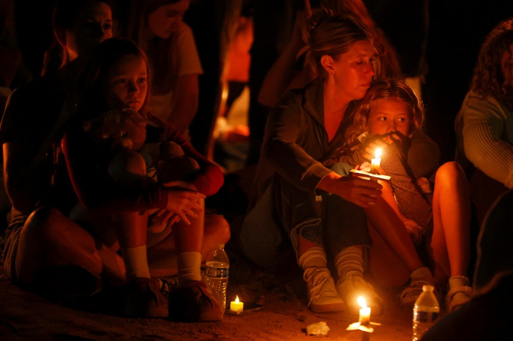 Mourners at a candlelight vigil.