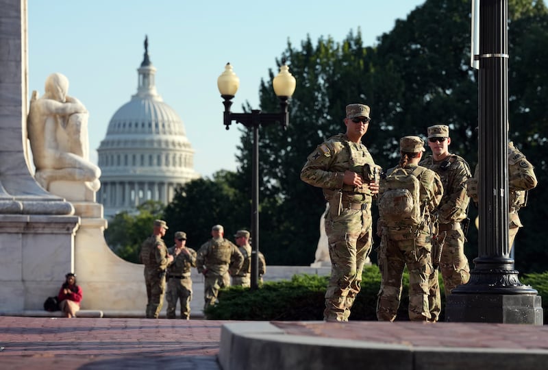 Members of the National Guard armed with sidearms patrol Union Station on August 25, 2025 in Washington, DC.