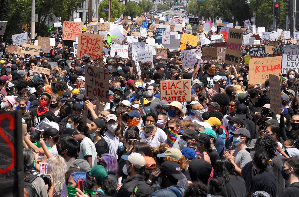 Demonstrators sit in an intersection during a protest over the death of George Floyd, on May 30, 2020, in Los Angeles.