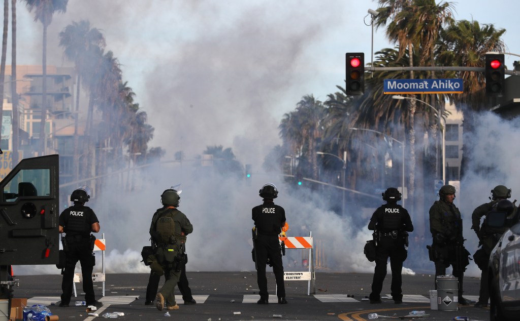 Police watch as tear gas is deployed during demonstrations in the aftermath of George Floydâs death on May 31, 2020 in Santa Monica, California. 