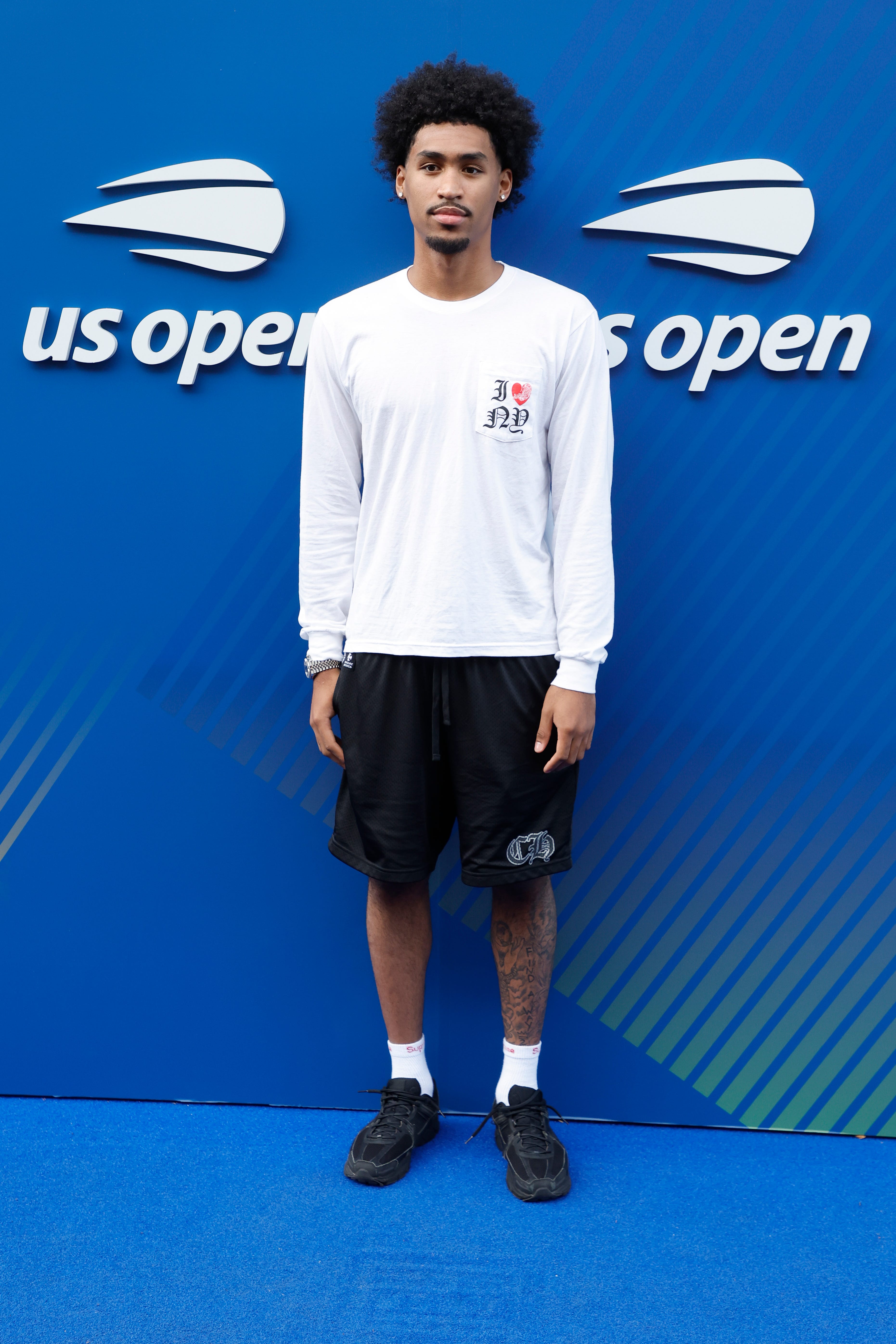Dylan Harper poses for photos at the US Open.