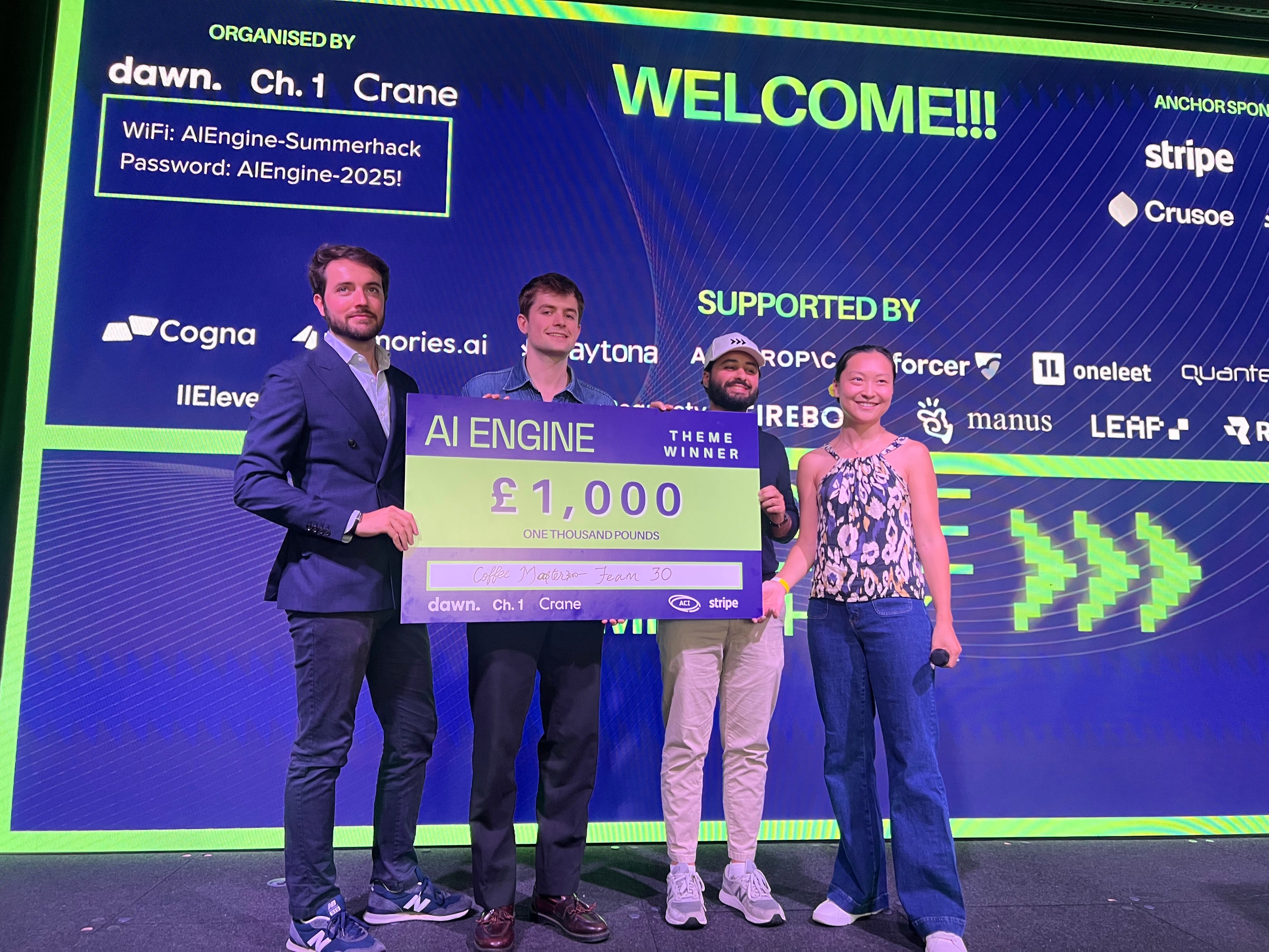 Alexander Cobb, second to left, holding a prize at the AI Engine hackathon.