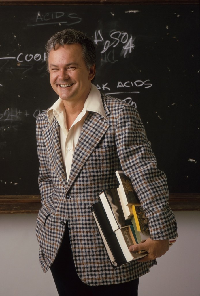 Portrait of Bob Crane holding books.