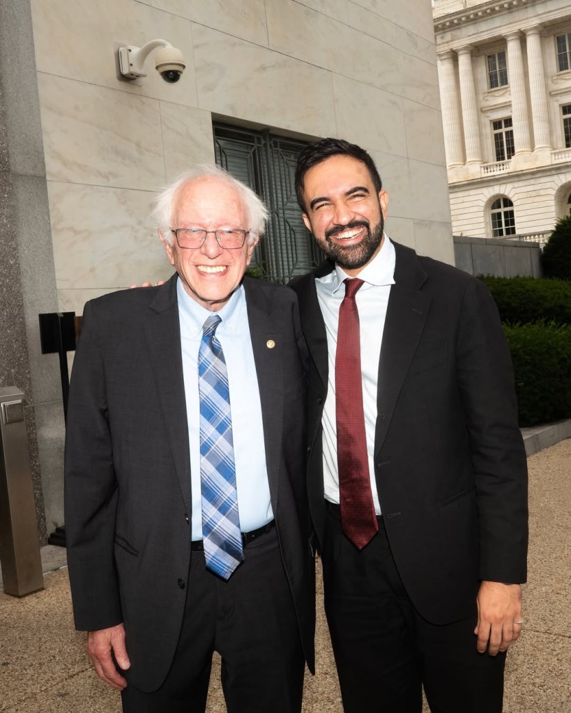 Bernie Sanders and Zohran Mamdani posing together.