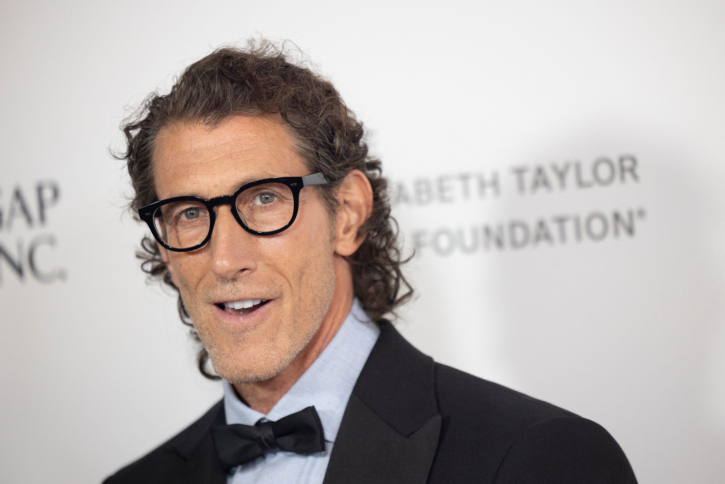 Gap CEO Richard Dickson in a suit and glasses