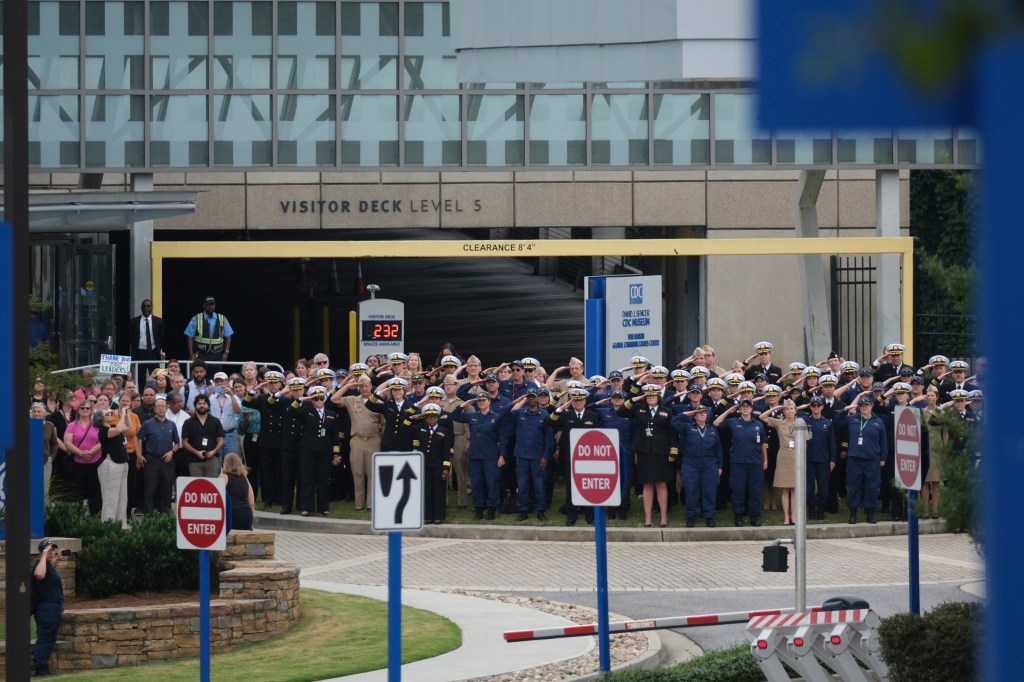 People saluting outside the CDC headquarters.