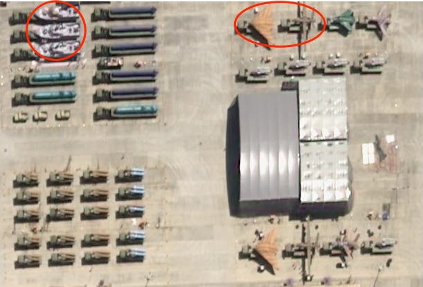 Two red circles highlight winged platforms and boat-like shapes mounted on trucks.