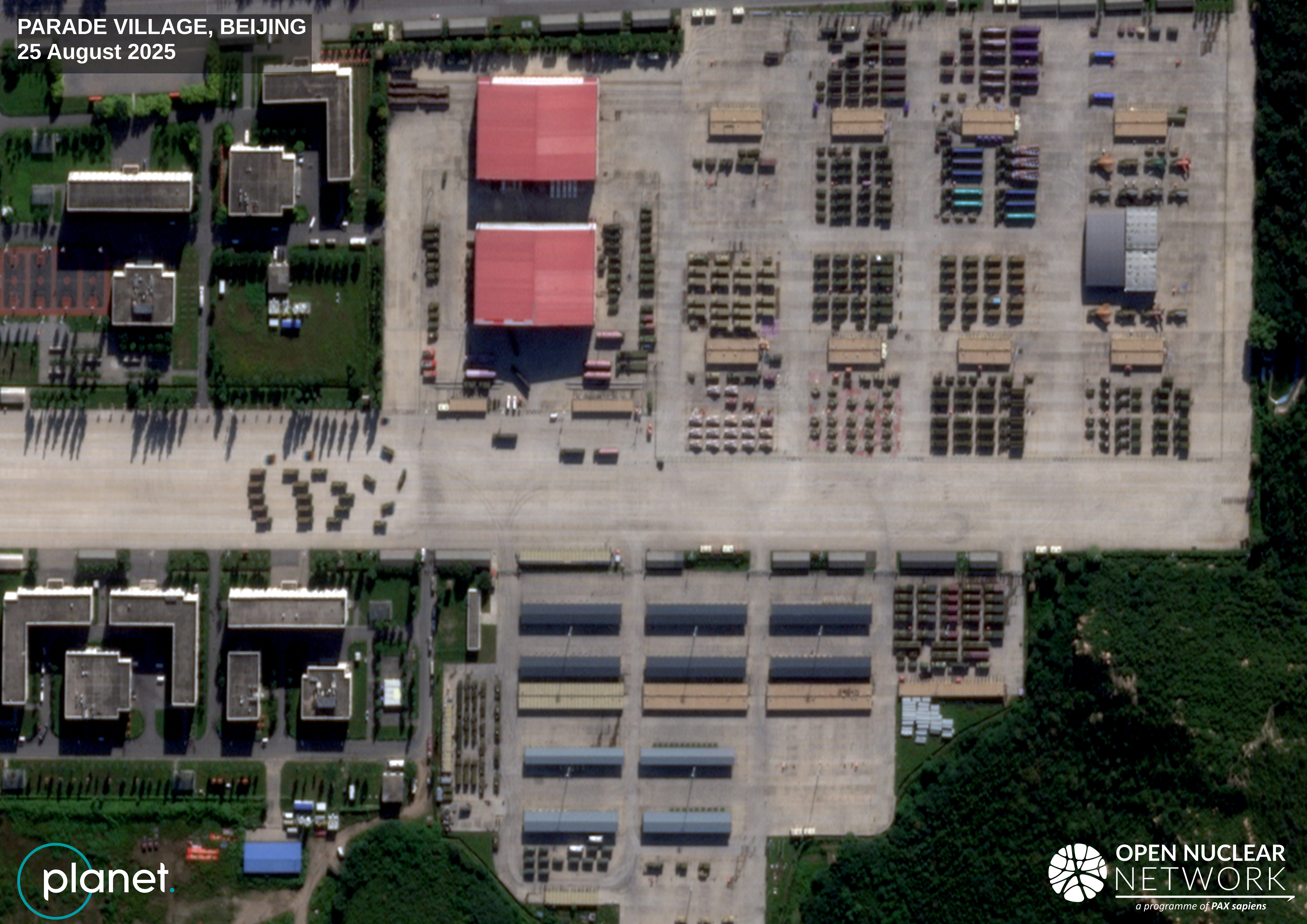 A zoomed out version of the parade village shows vehicles likely scheduled for display.