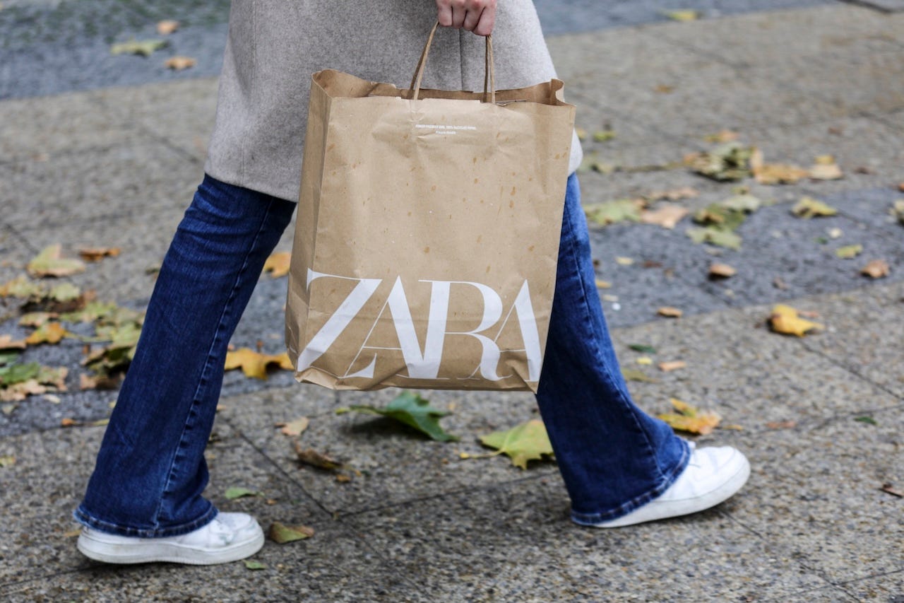 A Zara shopper carries a Zara bag.