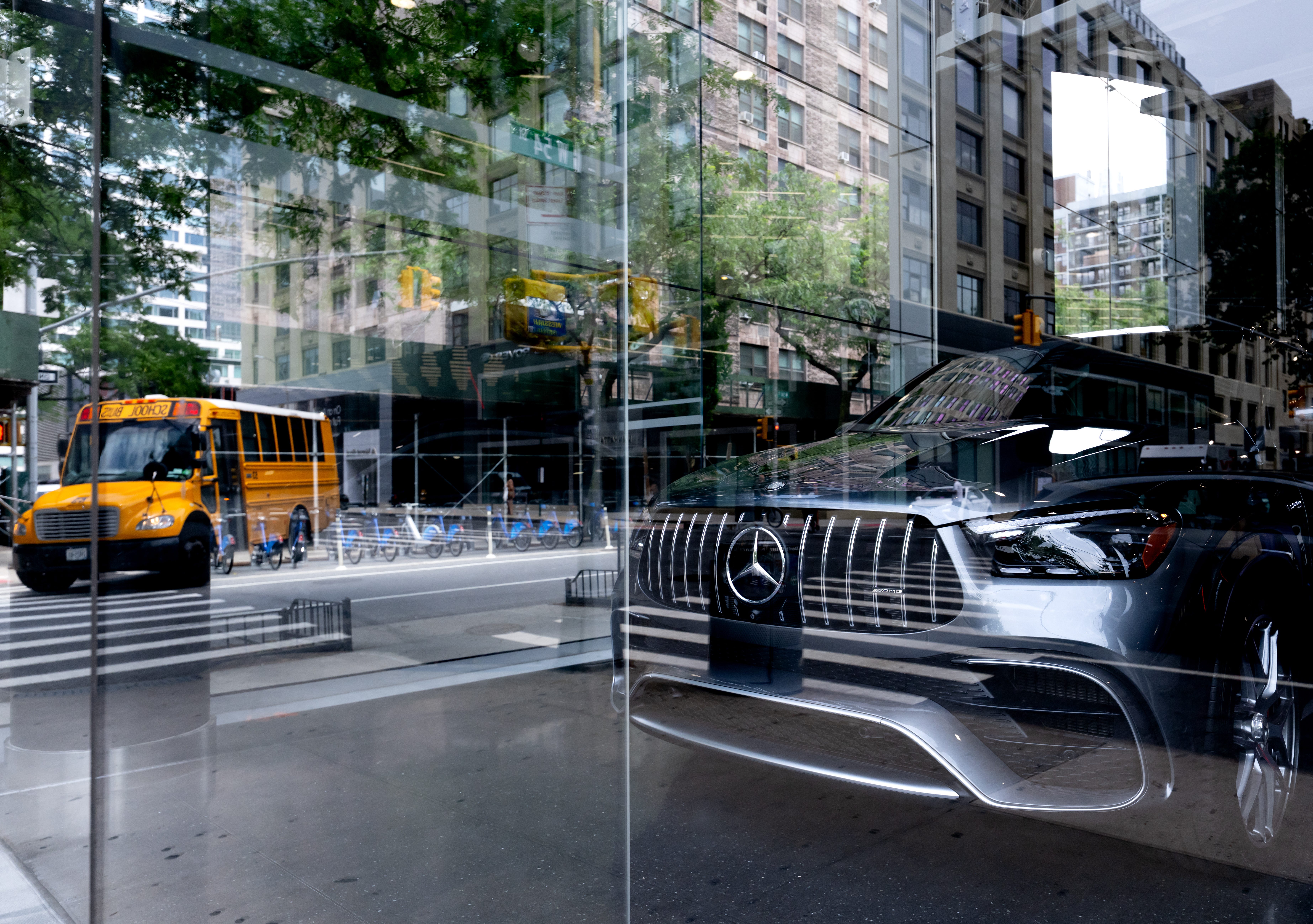 A Mercedes-Benz vehicle is parked in a car dealership in Manhattan.