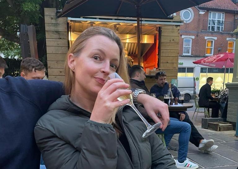 woman holding a glass of sparkling wine