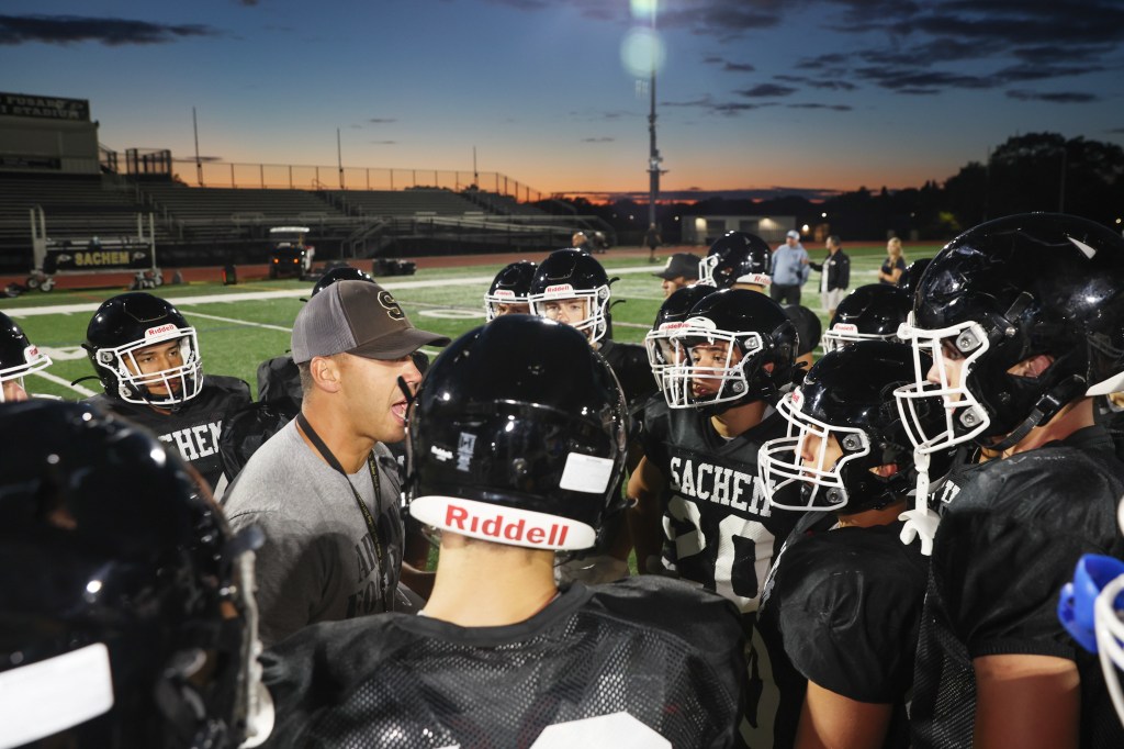 Sachem North coach David Caputo huddles up his team during a recent practice.