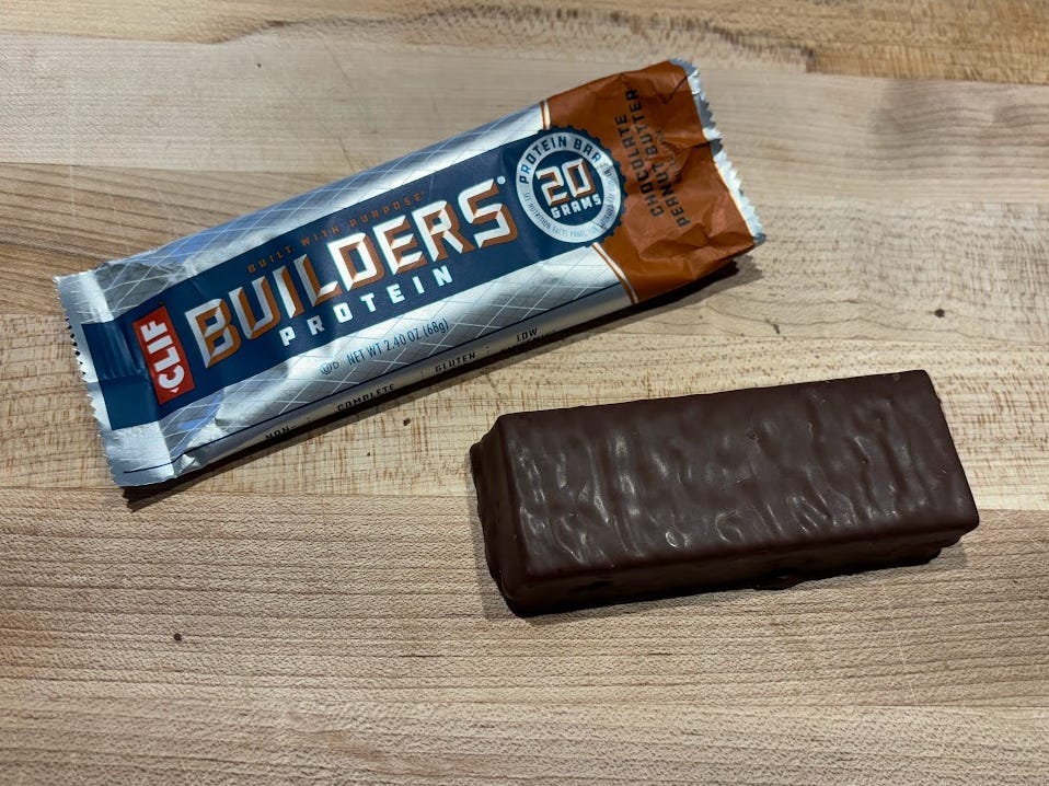 Clif Builders protein bar wrapper with unwrapped bar next to it