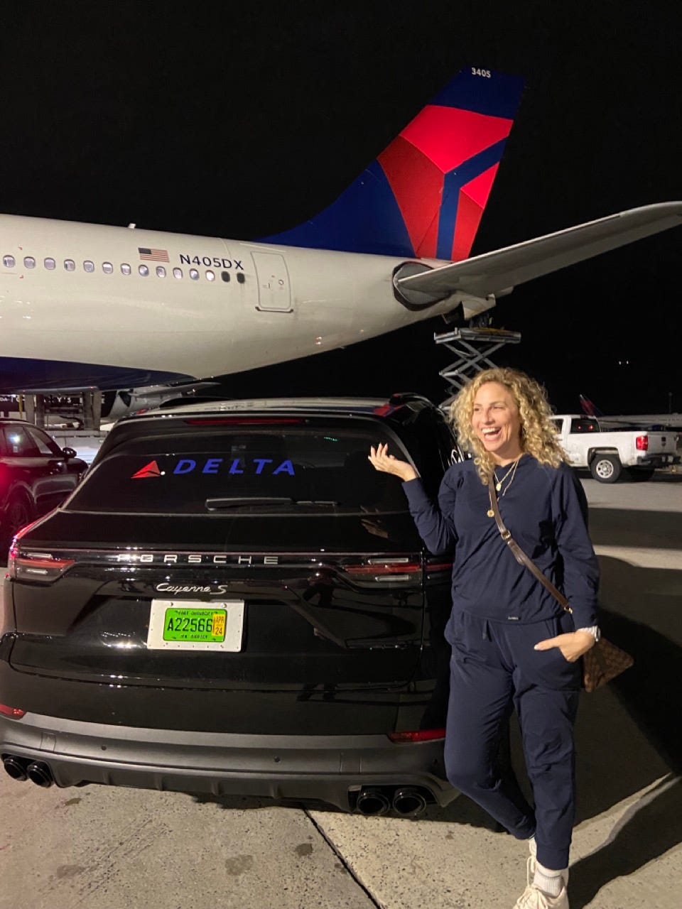 Author Alesandra Dubin smiling with porsche during Delta One transfer