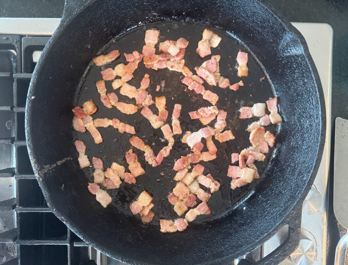 Pancetta cooking on the stovetop.