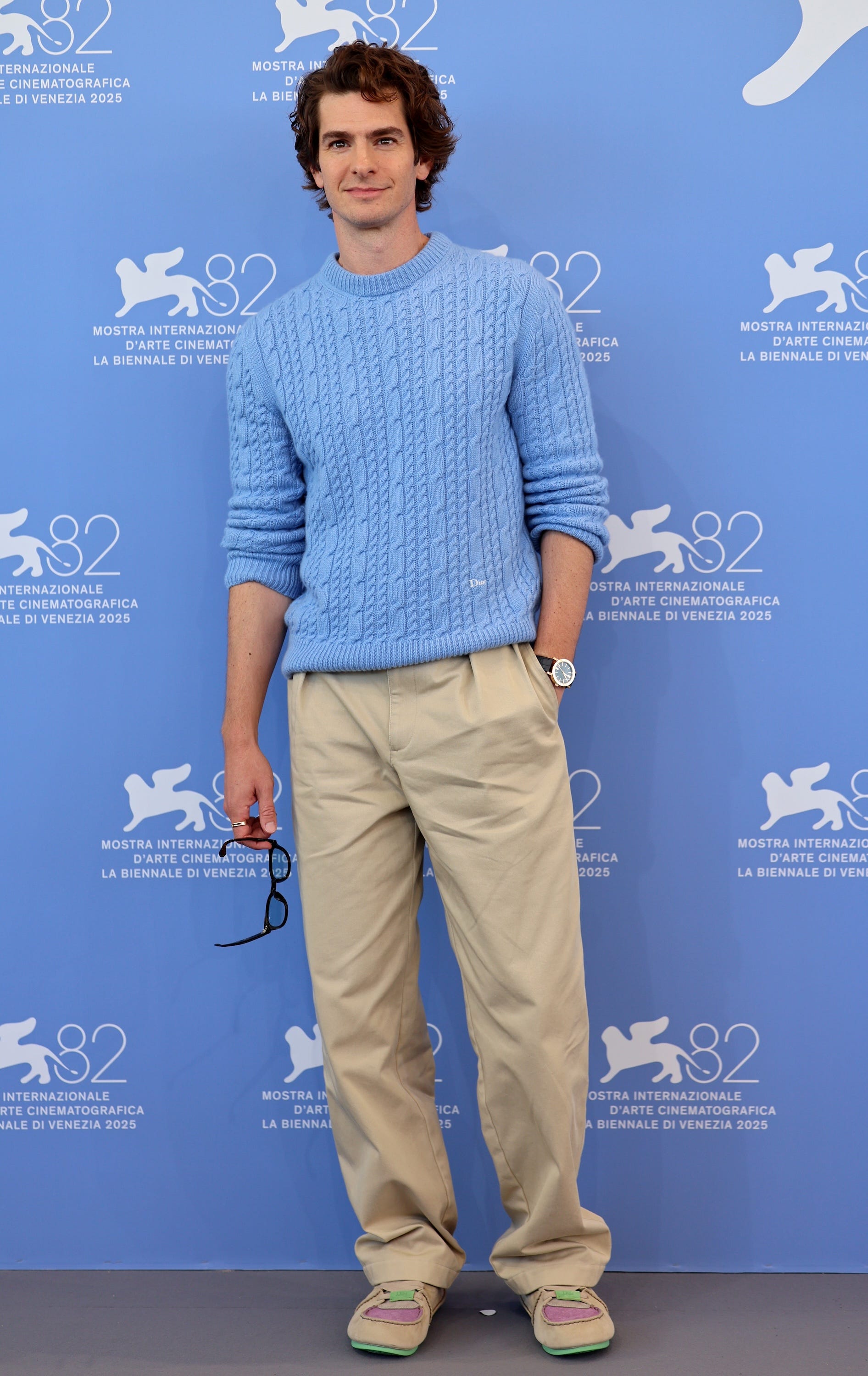 Andrew Garfield poses for photos at the Venice Film Festival.