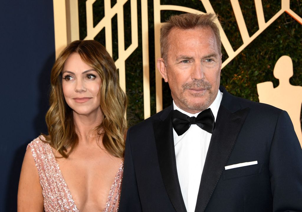 US actor Kevin Costner and his wife Christine Baumgartner arrive for the 28th Annual Screen Actors Guild (SAG) Awards at the Barker Hangar in Santa Monica, California, on February 27, 2022. (Photo by Patrick T. FALLON / AFP) (Photo by PATRICK T. FALLON/AFP via Getty Images)
