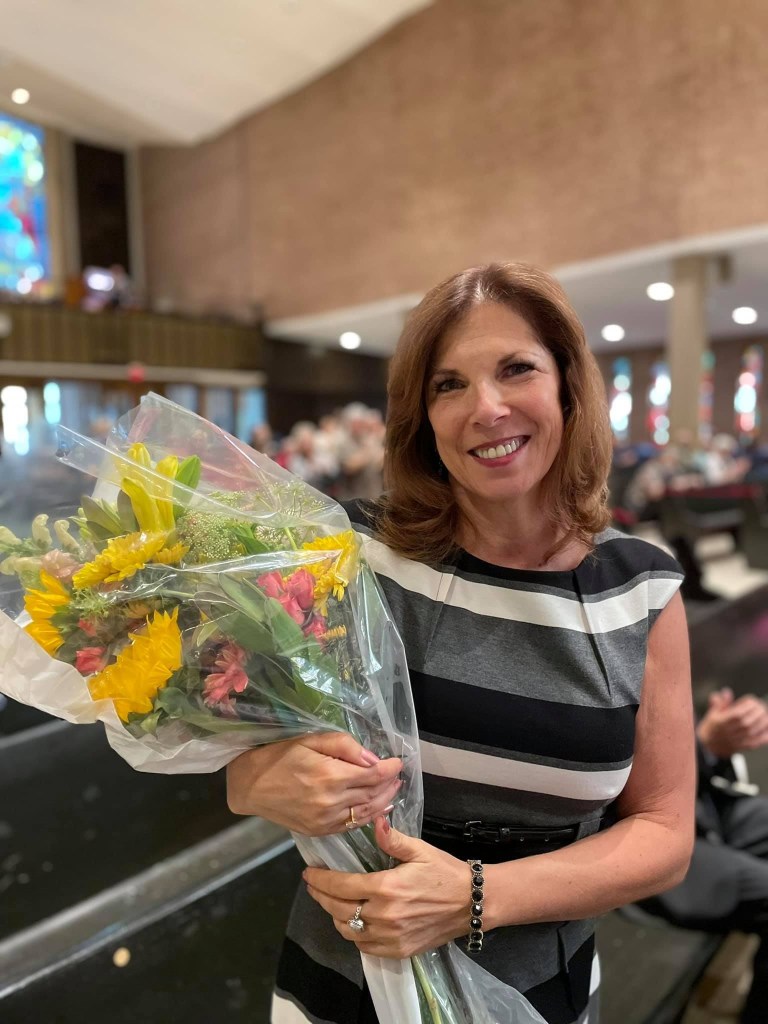 Mary Grace Westman holding a bouquet of flowers.