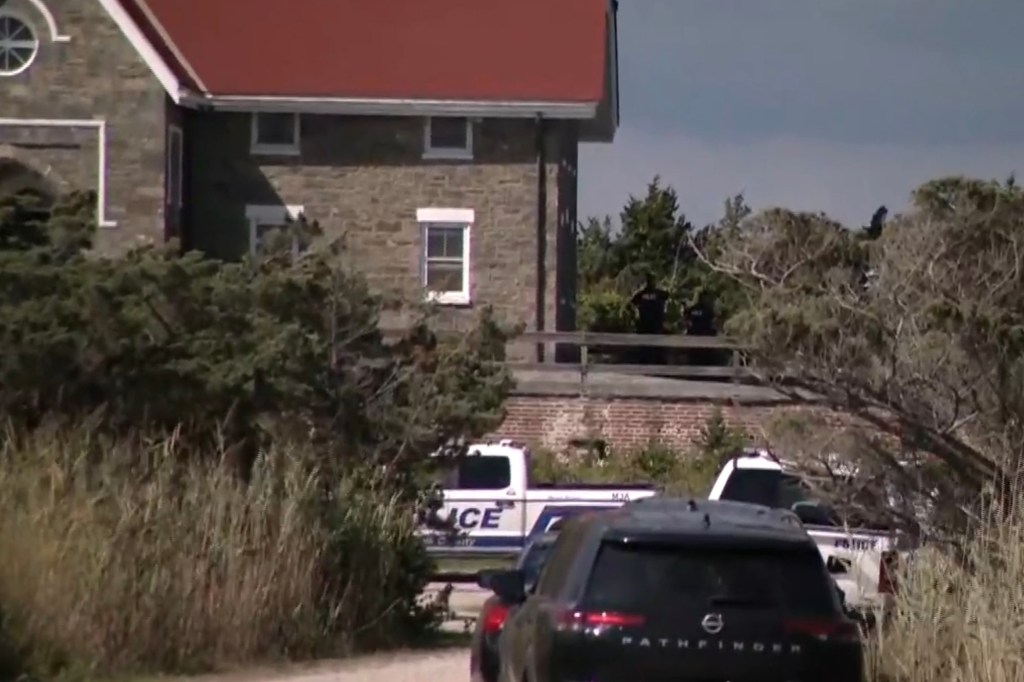 Police vehicles at Fire Island Lighthouse after a fatal fall.