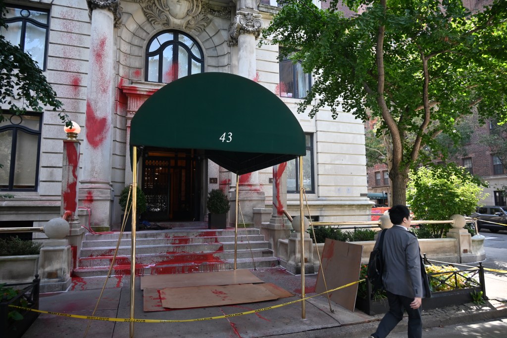 Red paint covered the front steps of the historic 1905 Beaux Arts building, where Kahn owns an apartment.