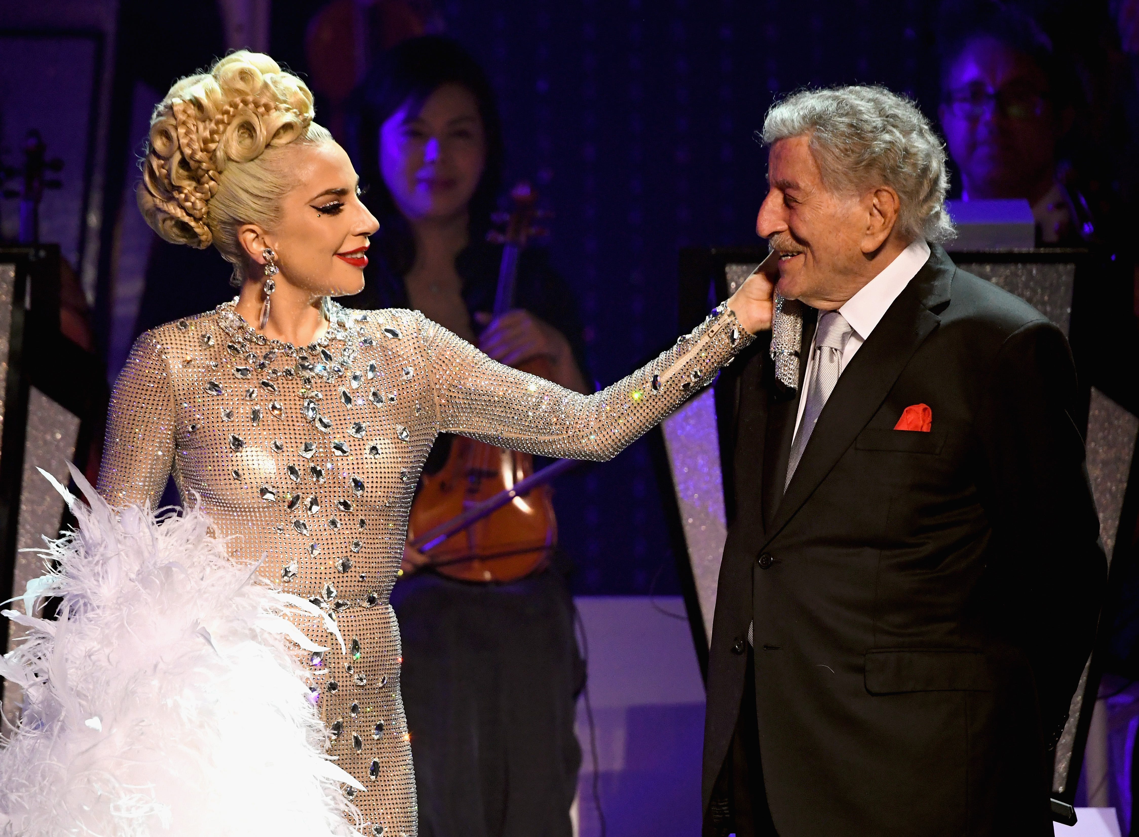 Lady Gaga caressing Bennett's face onstage.