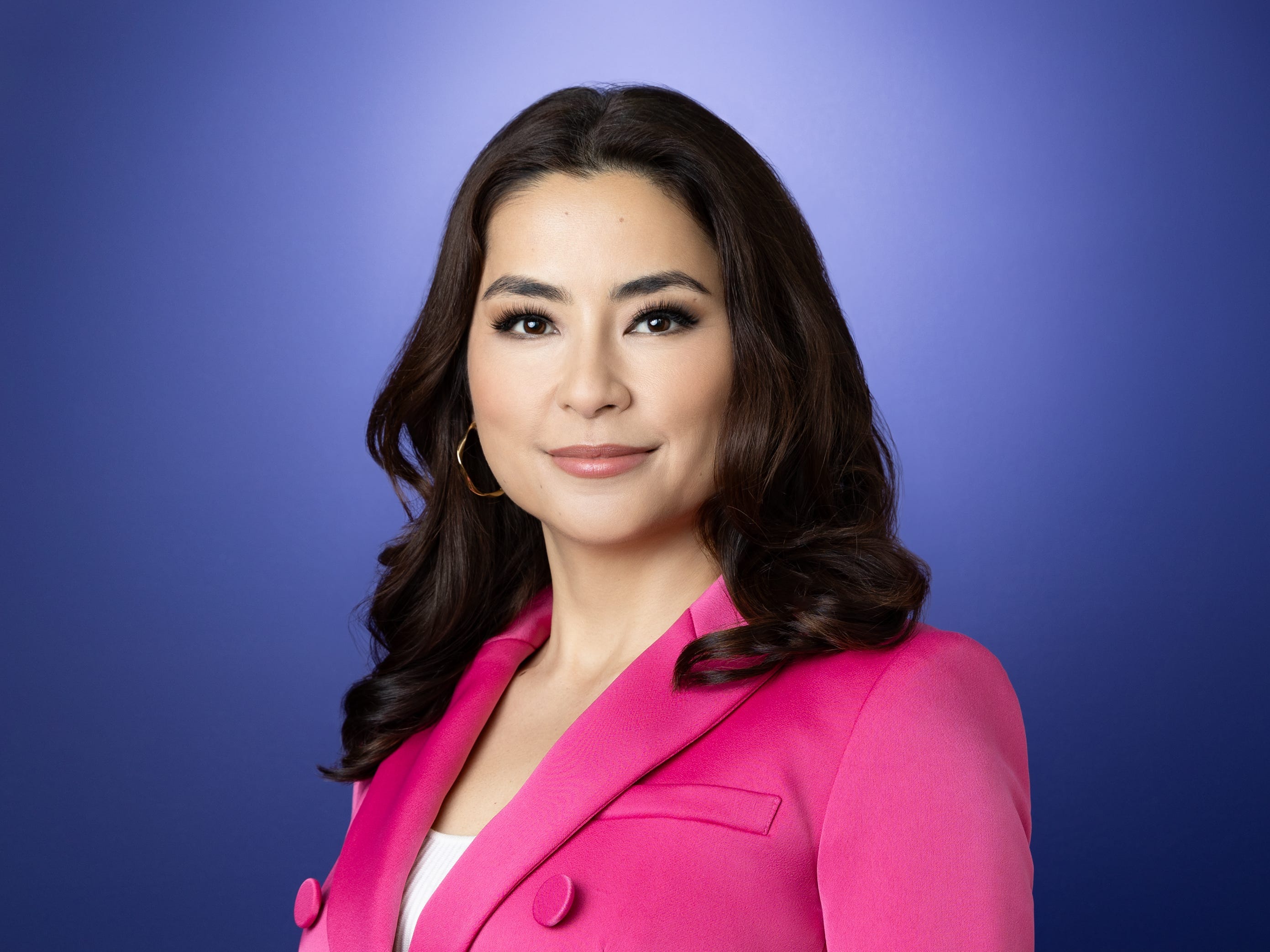 Maya Rogers, the CEO of Tetris, wearing a pink blazer and standing against a purple background.