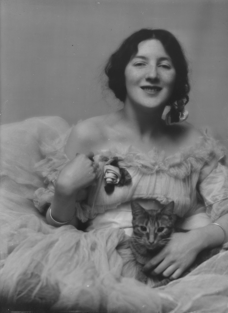 Black and white photo of Audrey Munson holding a cat.