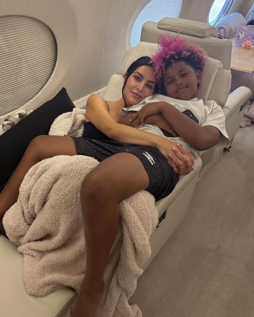 Kim Kardashian hugs her son Saint, 9, aboard  a private jet on a family trip to Cabo, Mexico, last week.
