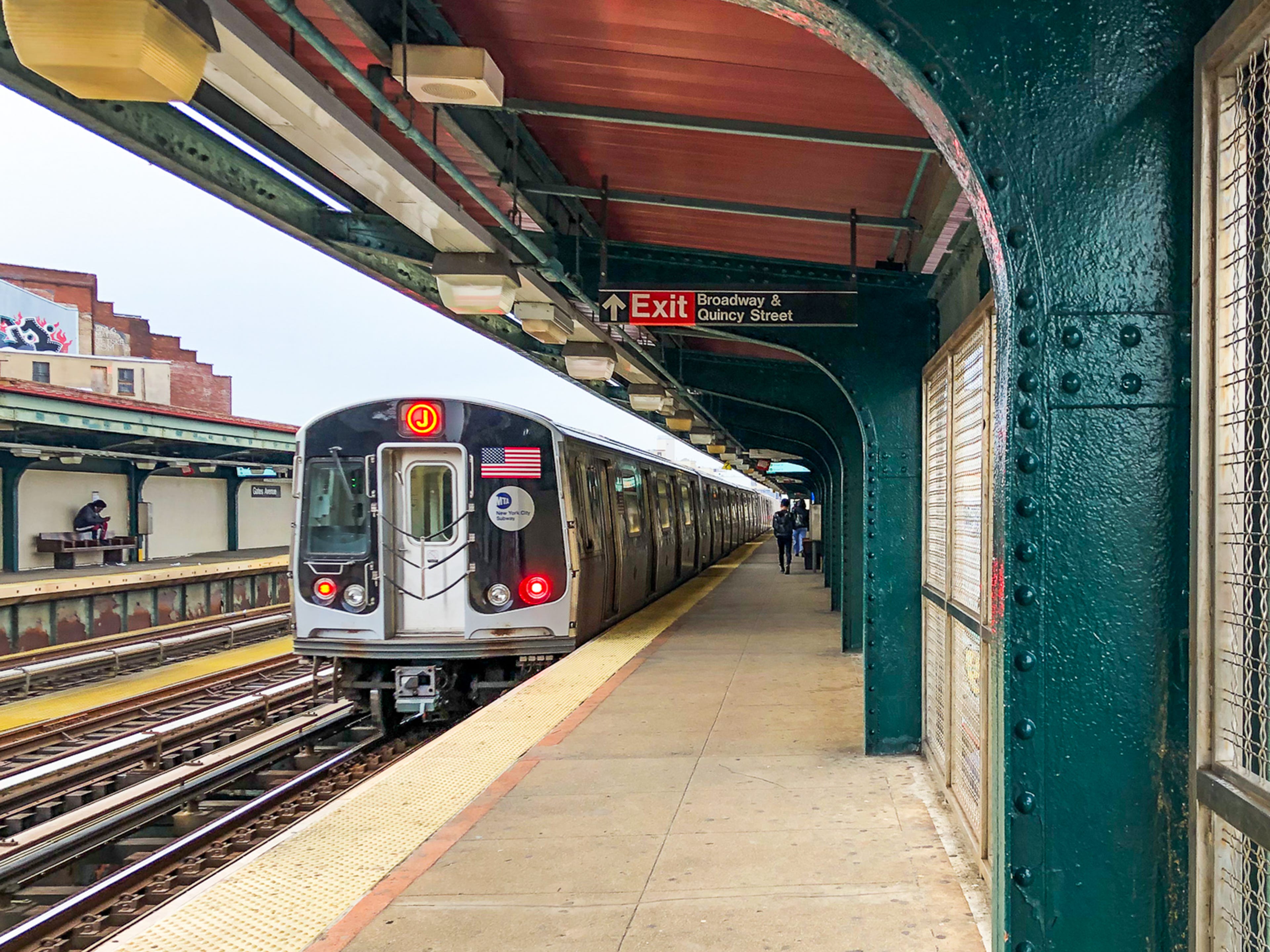 A subway stopped at an elevated train platform in Brooklyn