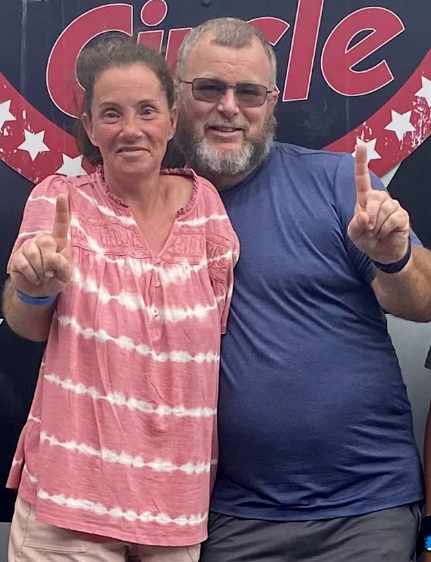 Couple holding up index fingers.