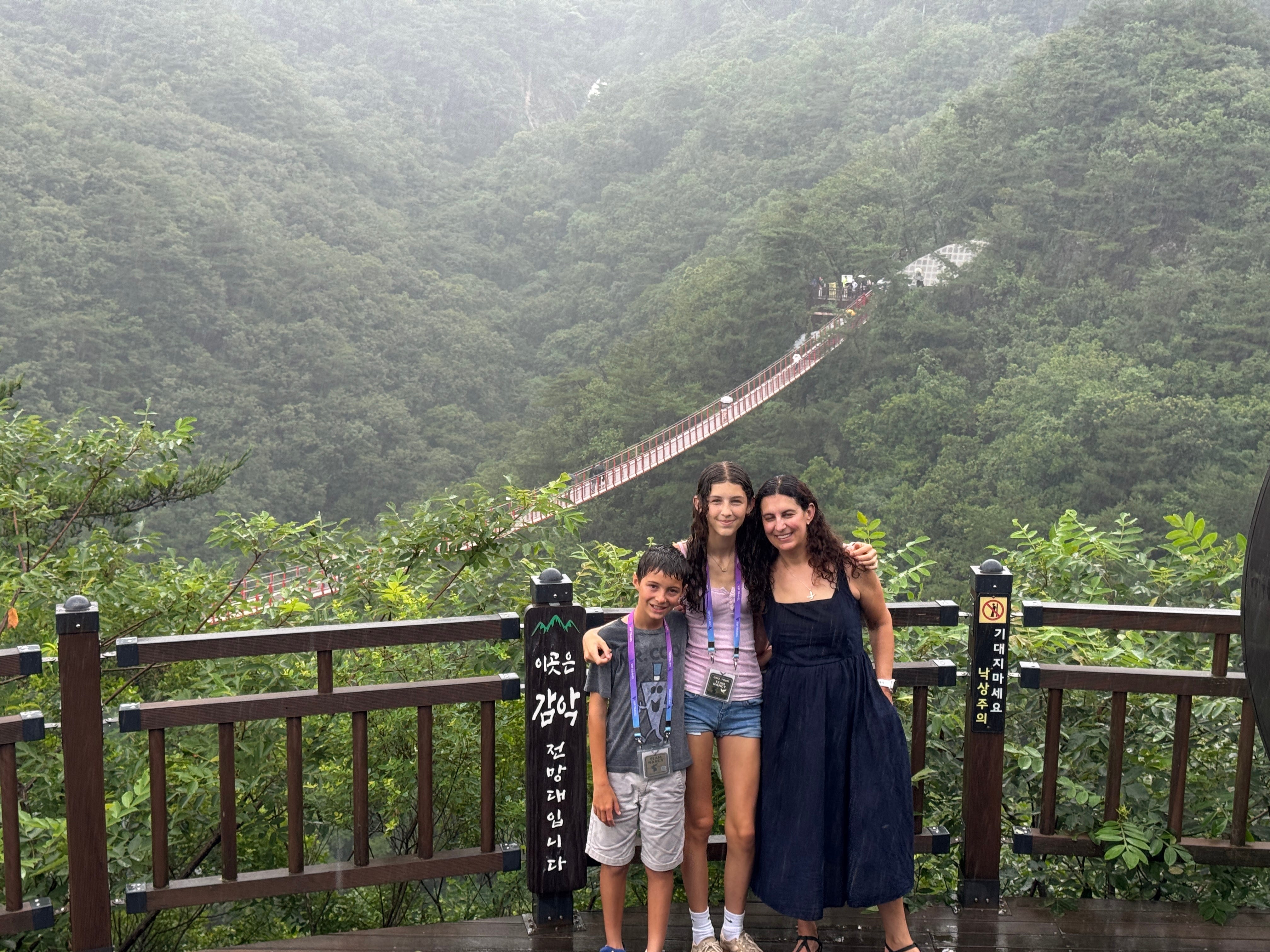 Mom and kids posing under the rain