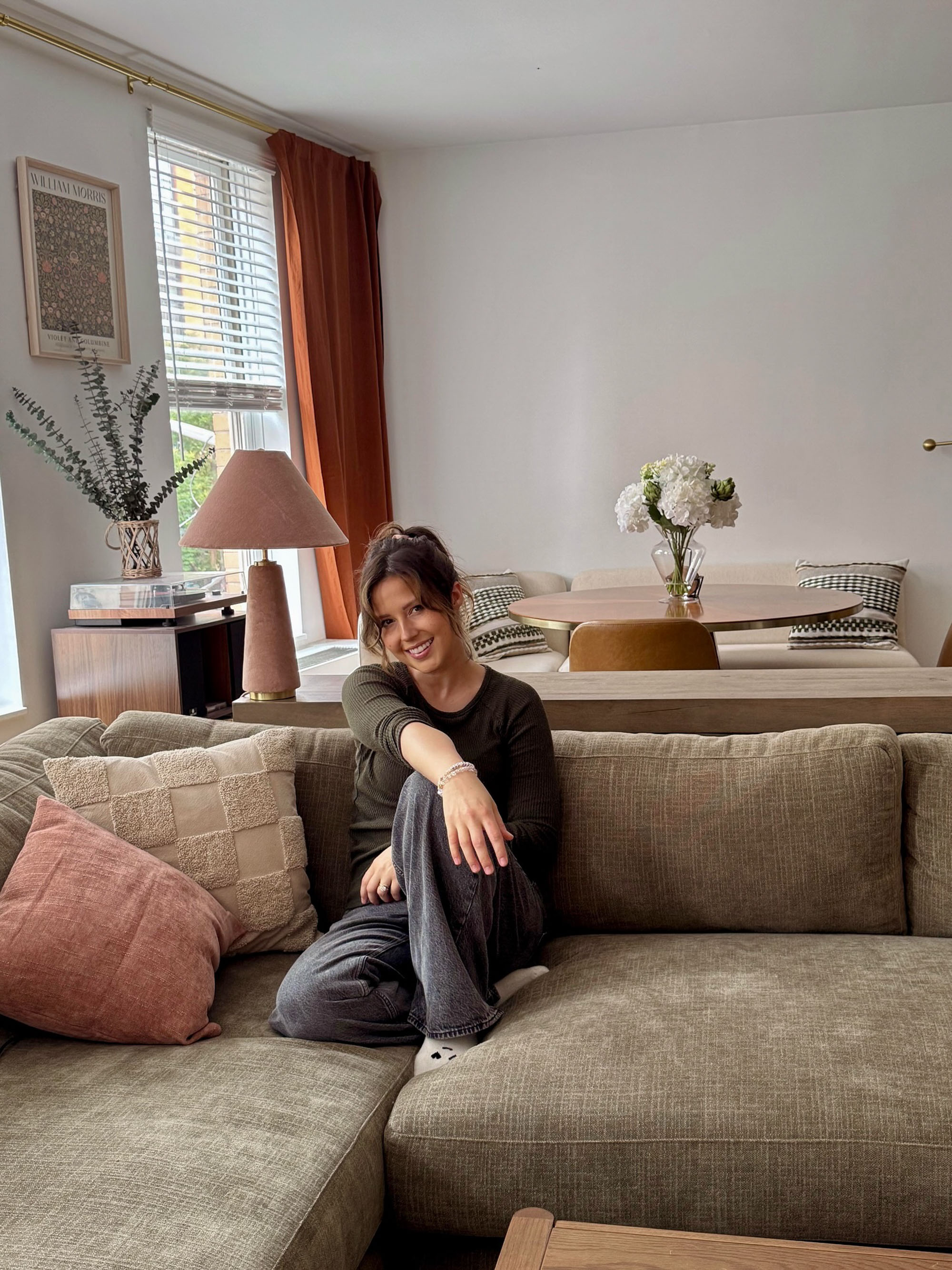 Katie Thurston on a couch. 