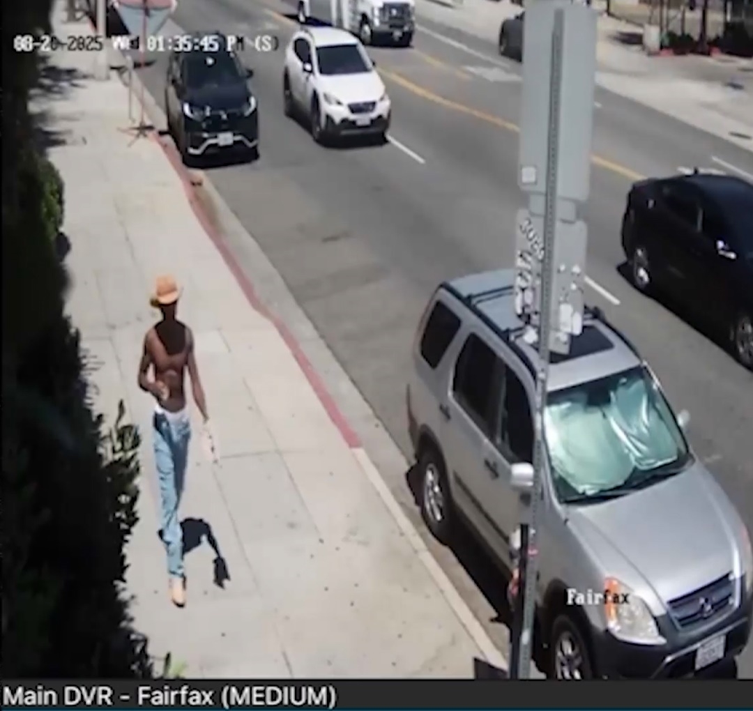Lil Nas X shirtless outside a hotel. 